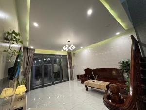 a living room with a couch and a table at Villa 26-28 Châu Đốc in Chau Doc +25 photos