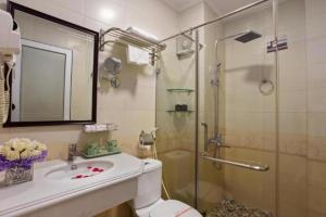 a bathroom with a toilet and a sink and a shower at Hanoi Impressive Hotel in Hanoi +85 photos
