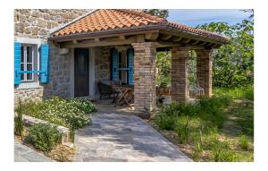 einem Pavillon mit einem Tisch vor einem Haus in der Unterkunft 1 Bedroom Amazing Home In Mundanije in Mundanije