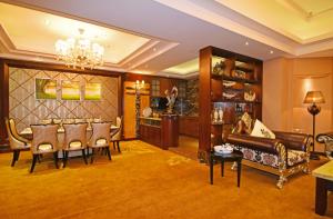 a living room with a couch and a dining room at The Bmc Hotel in Shenzhen