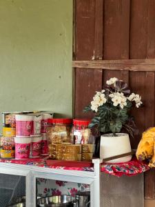 a table with some food and flowers on it at Me Vadsana Homestay in Ban Mae Khachan (1) +13 photos