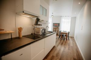 a kitchen with a counter top with a microwave at Les Anges 2 in Cambrai