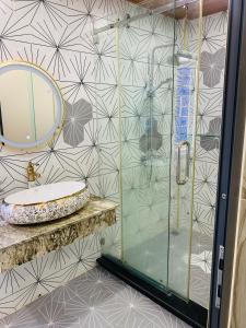 Un baño con ducha con lavabo y espejo. en THANH LUONG House, en Da Nang