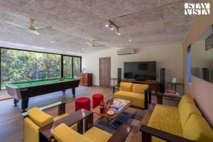 ein Wohnzimmer mit einem Billardtisch darin in der Unterkunft Nivaant Farms & Cottages - Nestled in lush greenery, offering a Swimming pool, Orchard, Jacuzzi & A spacious lawn with gazebo in Karjat