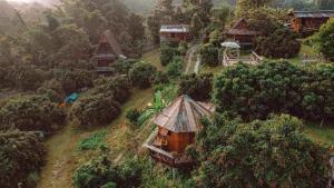 a small house on a hill in a forest at Baan 2 Dao Farmstay in Chiang Dao