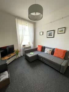 a living room with a couch and a television at Buttercup Cottage in Dundrum
