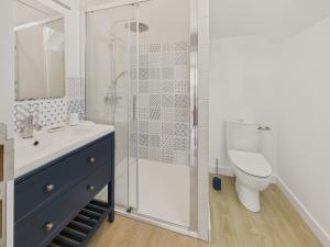 a bathroom with a shower and a toilet and a sink at Maison avec jardin pour 4 adultes et 2 enfants in Beg-Meil +13 photos