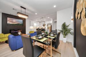 a dining room and living room with a table and chairs at The Prolific Stay - Where Luxury Meets Lifestyle in Houston