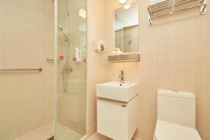 a bathroom with a shower and a toilet and a sink at Jinjiang Inn Select Shanghai Fengxian Baolong Square North Yunhe Road in Fengxian +118 photos