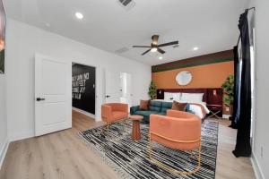 a living room with a couch and chairs and a bed at The Prolific Stay - Where Luxury Meets Lifestyle in Houston +54 photos