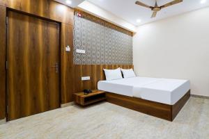 Postel nebo postele na pokoji v ubytování Hotel O GM