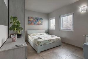 a bedroom with a bed and a potted plant at Downtown Pavia, a stone's throw from the station and the center in Pavia