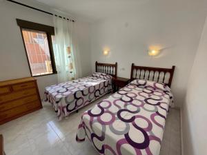 a bedroom with two beds and a window at Villa June in Benitachell +22 photos