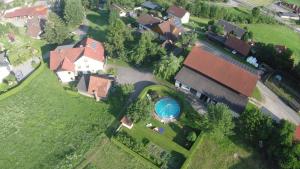 an overhead view of a house with a swimming pool at Osterbichlerhof in Feistritz am Kammersberg