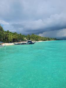 a view of a beach with boats in the water at Tara staycation unit in Boracay