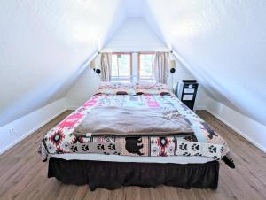a bedroom with a large bed in a attic at Fox n Bear Cottages Big Bear in Big Bear Lake