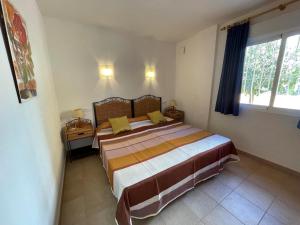 a bedroom with a bed with yellow pillows on it at Atico Vistamar X2113 in Benitachell