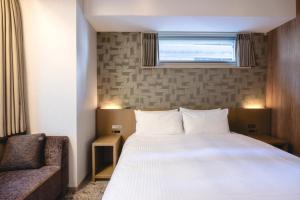 Postel nebo postele na pokoji v ubytování Hotel Gracery Ginza