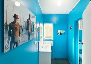 a blue bathroom with a sink and a mirror at & Art Motel in Tootgarook +35 photos
