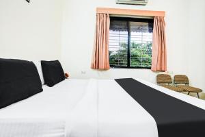 Postel nebo postele na pokoji v ubytování Super Hotel O Nashik + 21 fotografií