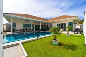 a house with a swimming pool in a yard at Modern Villa 3BR - Great Location - KL3 in Hua Hin