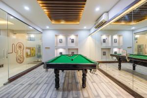 a billiard room with two pool tables and paintings at Tribe - Bespoke Hotel by FlxHo Arjun Marg DLF Phase 1 Golf Course Road in Gurgaon