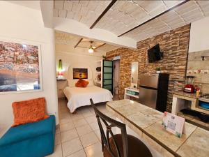 a living room with a bed and a kitchen at Surf in Sayulita