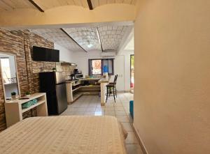 a room with a kitchen and a dining room at Surf in Sayulita