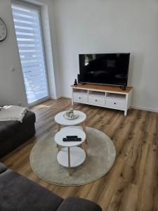 a living room with a couch and a tv at Ferienwohnung Ramona in Sonneberg