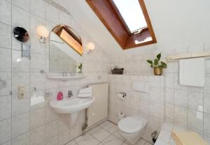 a white bathroom with a sink and a toilet at Studio Voglesang in Spiegelau