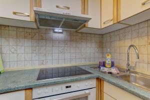 a kitchen with a sink and a stove at Wohnung Almberg in Spiegelau