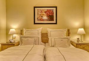 a bedroom with two beds and a painting on the wall at Siebensteinkopf in Spiegelau +16 photos