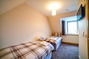 
a bedroom with a bed and a window at Kilcumin Guest House in Inverness
