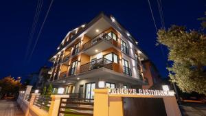 a building with a sign in front of it at Mucize Residence in Fethiye