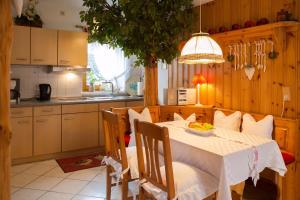 a kitchen with a table with a white table cloth at Ferienwohnung In Walkenried Mit Gepflegtem Garten in Walkenried