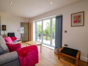 a living room with a couch and a large window at Highview Stables in Chesterfield