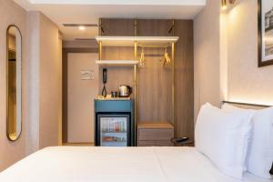 Postel nebo postele na pokoji v ubytování Emilion Hotel