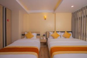 Postel nebo postele na pokoji v ubytování OYO 262 Hotel Kumari