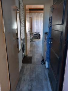 a hallway of a house with a door and a table at Le CENTAURE Proche Centre Naturiste in Cap d'Agde +7 photos
