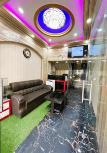 a living room with a couch and a tv at Hotel Anurag Palace In Agartala in Agartala