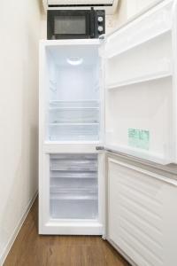 a white refrigerator with its door open at Laina Kyobashi2 in Osaka