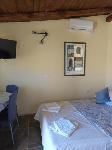 a bedroom with a bed and a table and a television at Panorama Studio in Skradin