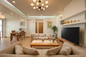 a living room with a couch and a flat screen tv at HTOWER - 197 Văn Cao, Gia Viên, Hải Phòng in Hai Phong