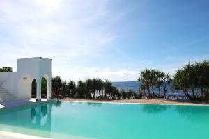 a swimming pool with a view of the ocean at Chalaroste Place by SMS Hospitality in Bolinao