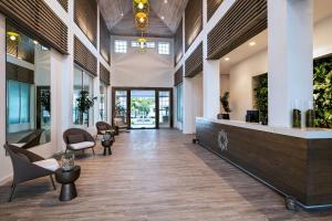 an office lobby with a reception desk and chairs at Alaia Belize, Autograph Collection in San Pedro +127 photos