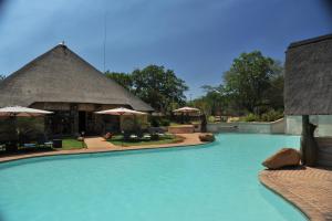 a swimming pool with blue water in a resort at Mabula Game Lodge in Warmbaths