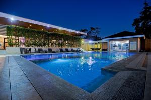 a swimming pool in a house at night at Holiday Suites Puerto Princesa in Puerto Princesa City