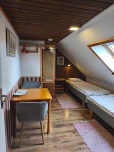 a room with two bunk beds and a table and chair at Pärna Guesthouse & Apartments in Kuressaare