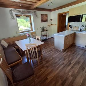 a kitchen and dining room with a table and chairs at Ferienwohnung Frauenkogelblick mit Terrasse in Grossarl