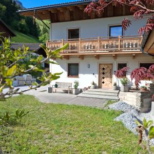 a house with a deck on the side of it at Ferienwohnung Frauenkogelblick mit Terrasse in Grossarl +20 photos